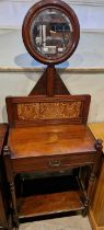 A late 19th century mahogany washstand, the circular bevelled glass mirror mounted to a raised