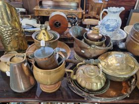 A large collection of copper and brass ware to include a copper helmet-shaped fuel bin, a brass fuel
