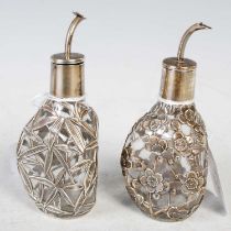 A pair of Sterling silver mounted clear glass dimple form vinaigrette bottles, one decorated with