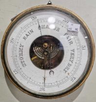 A 19th century circular wall barometer with black and white coloured dial.