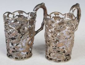 A pair of Chinese silver cupholders, makers mark of 'TC', probably Tuck Chang, pierced with