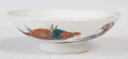 A Chinese porcelain footed shallow dish, the underside decorated with dragon, fish and other sea-