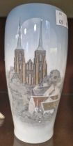 A Royal Copenhagen porcelain bullet-shaped vase decorated with a cathedral, 16.5cm high.
