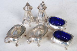 A Birmingham silver six-piece cruet set comprising two pepper pots, two salts with blue glass liners