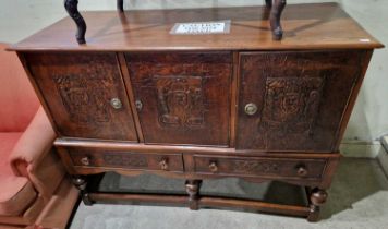 An early 20th century oak and embossed leather cabinet on stand with retailers plaque 'Ray and Miles