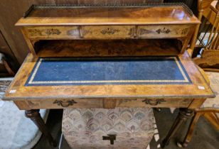 An 19th century burr walnut and boxwood lined writing table, the upper section with three quarter