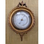 An early 20th century compensated circular wall barometer in Neoclassical style gilded frame.