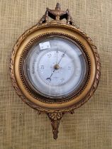 An early 20th century compensated circular wall barometer in Neoclassical style gilded frame.