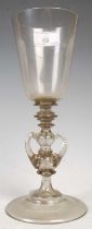 A late 19th / early 20th century continental clear glass goblet, set on knopped stem with three