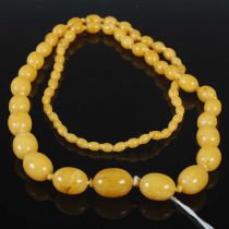 A vintage graduated amber type bead necklace, gross weight 58 grams.