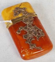 An antique yellow metal mounted amber cheroot holder, with yellow metal inlay of scrolling