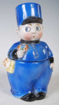 An early 20th century novelty porcelain box and cover modelled as a boy gendarme/ policeman, 16.