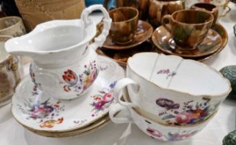 A Continental porcelain group comprising two breakfast cups, three saucers and a milk jug, all