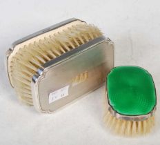 A Birmingham silver and green enamel hair brush together with a pair of Birmingham silver backed