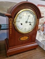 A reproduction Edwardian style mahogany and inlaid break-arch mantle clock with Arabic numeral