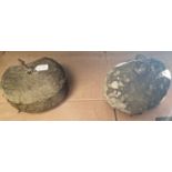 An antique curling stone / counterweight, together with another stone counter weight.