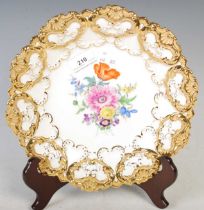 A Meissen porcelain cabinet plate with hand-painted spray of colourful flowers within a richly