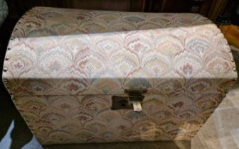 A late 19th century dome top storage trunk with all-over needlework upholstery and studded