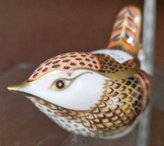 A Royal Crown Derby model of a bird with silver button.