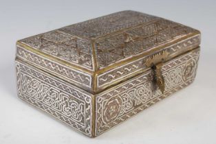 A Mamluk Revival Islamic silver inlaid brass box, the tapering hinged cover with central panel of