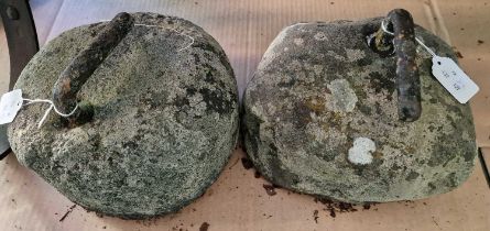 Two antique curling stones.