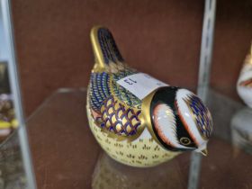 A Royal Crown Derby model of a bird with gold coloured button.