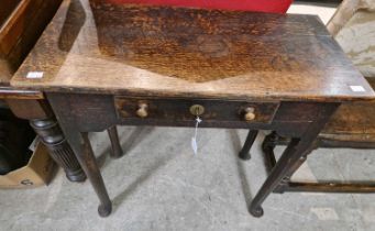 A late 18th / early 19th century oak side table with single frieze drawer raised on four tapered