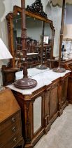 A 19th century walnut and inlaid mirror back credenza, the mirror back with surmount of carved