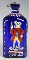 An antique continental cobalt blue glass decanter, with polychrome decoration of a figure holding