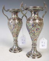 A pair of Persian white metal and enamel twin-handled vases, late 19th century, decorated with