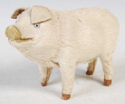 An antique novelty key wind music box in the form of a pig, 14cm long x 8.5cm high.