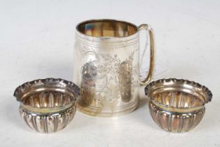 A Birmingham silver christening mug with shield shaped cartouche, left vacant, together with a