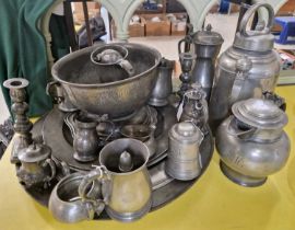 A large collection of antique pewter ware to include a pair of candlesticks, tankards, tappit