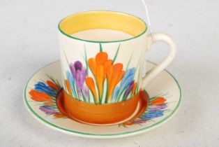 A Clarice Cliff Bizarre crocus pattern hand-painted coffee cup and saucer.