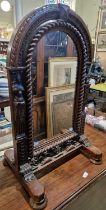 A 19th century oak carved dressing table mirror of arched form.