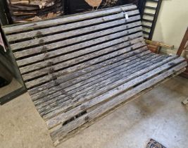 A pair of 19th century cast iron garden benches with wooden slatted seats.