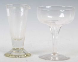 An early 20th century clear glass champagne coupe, 11cm high, together with an antique glass