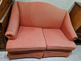 A 20th century Parker Knoll two-seat sofa of neat proportions in burnt orange coloured upholstery.