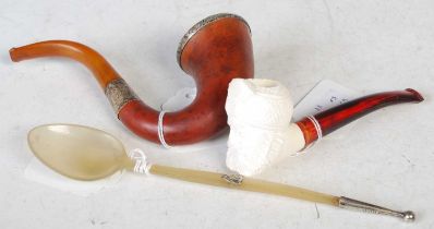 A Birmingham silver mounted pipe, a carved Meerschaum type pipe, the bowl formed as the head of