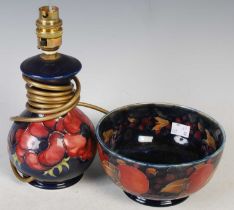 Two pieces of Moorcroft Pottery to include a blue ground table lamp base decorated with anemones,