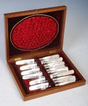 A cased set of six mother of pearl handled fruit knives and forks with Sheffield silver blades and