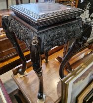 A Chinese stained wood jardiniere, with carved floral detail, raised on four cabriole supports, 61cm