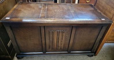 A 20th century oak blanket box, raised on four bun feet, 95cm wide.