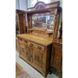 A 19th century carved oak mirror-back sideboard, the upper section with break-arch surmount with