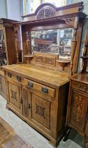 A 19th century carved oak mirror-back sideboard, the upper section with break-arch surmount with