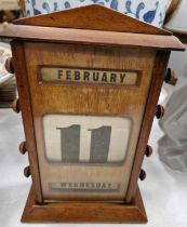 A late 19th / early 20th century mahogany cased desk calendar.