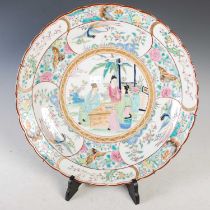 A Chinese porcelain famille rose charger, 20th century, decorated with figures seated at a table