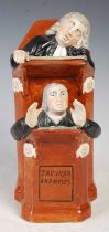 A late 18th century Staffordshire pottery figure group, titled 'THE VICAR AND MOSES', the reverse