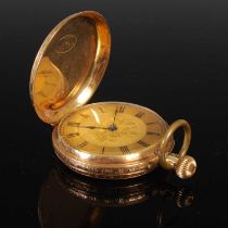 A yellow metal hunter cased pocketwatch with black Roman numeral dial, the case with engine turned