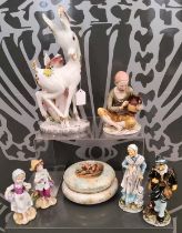 A collection of Continental ceramics to include an Italian figure of a doe, a female figure carrying
